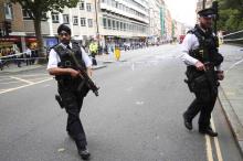 Armed police officers patrol at the scene of a knife attack in Russell Square in London, Britain, August 4, 2016. PHOTO BY REUTERS/Neil Hall