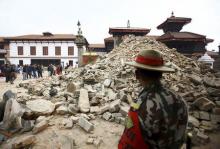 A Nepalese army personnel stands in front of a collapsed temple a day after an earthquake in Bhaktapur, Nepal April 26, 2015. PHOTO BY REUTERS/Navesh Chitrakar