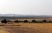 Turkish armoured personnel carriers drive towards the border in Karkamis on the Turkish-Syrian border in the southeastern Gaziantep province, Turkey, August 27, 2016. PHOTO BY REUTERS/Umit Bektas