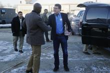U.S. Secretary of Defense Ash Carter (C) is greeted by Senior Military Assistant U.S. Army Major General Ron Lewis (L) as they arrive to travel to Afghanistan from Joint Base Andrews, Maryland, February 20, 2015. PHOTO BY REUTERS/Jonathan Ernst