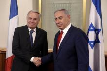 Israeli Prime Minister Benjamin Netanyahu (L) shakes hands with French Foreign Minister Jean-Marc Ayrault on May 15, 2016 during a meeting at the Prime Minister's office in Jerusalem. PHOTO BY REUTERS/Menahem Kahana