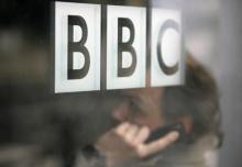 A man talks on a mobile phone inside the BBC headquarters in London, November 21, 2008. PHOTO BY REUTERS/Andrew Winning
