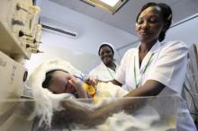 A nurse weighs a baby at the Maitama district hospital in Nigeria's capital Abuja May 22, 2011. REUTERS/Akintunde Akinleye