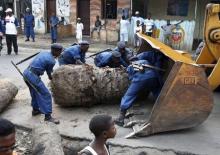 Policemen clear a barricade set up by by protesters, who are against President Pierre Nkurunziza's decision to run for a third term, in Bujumbura, Burundi, May 30, 2015. PHOTO BY REUTERS/Goran Tomasevic