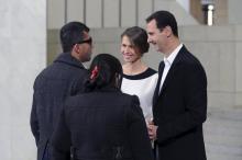 Syria's President Bashar al-Assad stands next to his wife Asma as they welcome injured soldiers and their mothers during a celebration marking Syrian Mother's Day in Damascus, March 21, 2016. PHOTO BY REUTERS/SANA