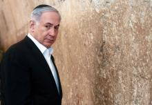 Israel's Prime Minister Benjamin Netanyahu stands next to the Western Wall, Judaism's holiest prayer site, during a visit in Jerusalem's Old City, February 28, 2015. PHOTO BY REUTERS/Marc Sellem