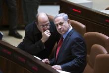 Israel's Defence Minister Moshe Yaalon (L) speaks with Prime Minister Benjamin Netanyahu during a session of the Knesset, the Israeli parliament, in Jerusalem, December 1, 2014. PHOTO BY REUTERS/Ronen Zvulun