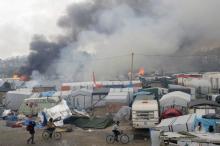 Smoke rises the sky as makeshift shelters and tents burn in the "Jungle" on the third day of the evacuation of migrants and their transfer to reception centers in France, as part of the dismantlement of the camp in Calais, France, October 26, 2016. PHOTO BY REUTERS/Philippe Wojazer