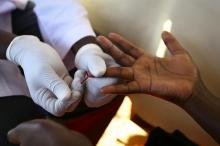 A doctor draws blood from a man to check for HIV/AIDS at a mobile testing unit in Ndeeba, a suburb in Uganda's capital Kampala, May 16, 2014. PHOTO BY REUTERS/Edward Echwalu