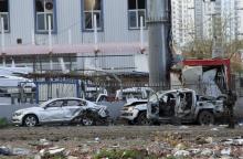 A member of the police special forces stands next to vehicles, which were damaged by a car bomb attack that targeted a minibus (not pictured) carrying members of the police special forces, occurred in the Kurdish-dominated southeastern city of Diyarbakir, Turkey, March 31, 2016. PHOTO BY REUTERS/Stringer