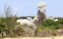 A bomb expert walks away as a cloud of smoke bellows in the air when explosives seized from two suspected Somali Islamist militants were detonated, in the Mtwapa area near Kenya's coastal city of Mombasa, March 20, 2014. PHOTO BY REUTERS/Joseph Okanga