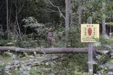 A Russian border marker (L) and an Estonian warning sign are pictured near the Estonian-Russian border, where, according to Estonia's officials, its security officer Eston Kohver was abducted in the south-east part of country, near the village of Miikse, September 7, 2014. PHOTO BY REUTERS/Ints Kalnins