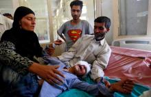 Parents comfort their son whom they say was injured by pellets shot by security forces in Srinagar following weeks of violence in Kashmir, August 18, 2016. PHOTO BY REUTERS/Cathal McNaughton