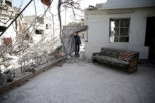A boy inspects a damaged house in the rebel-held besieged city of Douma, a suburb of Damascus, Syria, February 27, 2016. PHOTO BY REUTERS/Bassam Khabieh