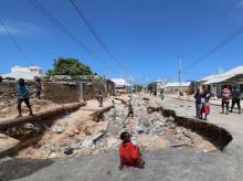 Children play near a road destroyed by rain water that flooded their street in Mogadishu, Somalia, May 21, 2018. PHOTO BY REUTERS/Feisal Omar