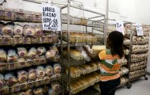 A worker arranges bread for sale inside a supermarket in Zimbabwe's capital Harare. PHOTO BY REUTERS/Philimon Bulawayo