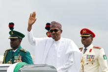 Nigerian President Muhammadu Buhari waves at the crowd during a celebration ceremony marking Democracy Day in Abuja, Nigeria, June 12, 2019. PHOTO BY REUTERS/Afolabi Sotunde