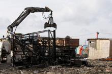 A bulldozer is used to remove debris as workmen tear down makeshift shelters during the dismantlement of the camp called the "Jungle" in Calais, France, October 27, 2016. PHOTO BY REUTERS/Pascal Rossignol