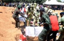 Tanzanian security agents and volunteers bury the coffins of containing the bodies of passengers retrieved after MV Nyerere ferry overturned off the shores of Ukara Island in Lake Victoria, Tanzania, September 23, 2018. PHOTO BY REUTERS/Stringer