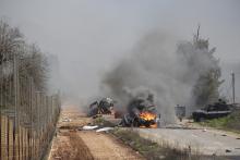 Burning vehicles are seen near the village of Ghajar on Israel's border with Lebanon, January 28, 2015. A Hezbollah missile strike wounded four Israeli soldiers on Wednesday, the biggest attack on Israeli forces by the Lebanese guerrilla group since a 34-day war in 2006. PHOTO BY REUTERS/Maruf Khatib