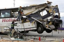 Workers cut away debris from the front of a bus involved in a mass casualty crash on the westbound Interstate 10 freeway near Palm Springs, California, October 23, 2016. PHOTO BY REUTERS/Sam Mircovich