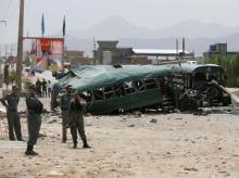 Afghan security forces inspect the damage on one of the buses hit by suicide bombers at the site of an attack on the western outskirts of Kabul, Afghanistan, June 30, 2016. PHOTO BY REUTERS/Omar Sobhani