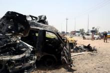 Destroyed vehicles are seen at the site of a suicide car bomber in Khalis, north of Baghdad, Iraq, July 25, 2016. PHOTO BY REUTERS/Stringer