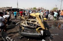 People gather at the site of a car bomb attack in Baghdad's mainly Shi'ite district of Sadr City, Iraq, May 17, 2016. PHOTO BY REUTERS/Khalid al Mousily