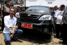 Then-mayor of Solo Joko Widodo poses with a locally made Esemka car, February 25, 2012. PHOTO BY REUTERS/Dhoni Setiawan