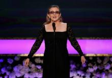 Actress Carrie Fisher introduces her mother, actress Debbie Reynolds, as the recipient of the Life Achievement Award at the 21st annual Screen Actors Guild Awards in Los Angeles, California January 25, 2015. PHOTO BY REUTERS/Mario Anzuoni