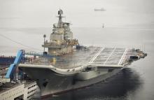 China's first aircraft carrier, which was renovated from an old aircraft carrier that China bought from Ukraine in 1998, is seen docked at Dalian Port, in Dalian, Liaoning province, September 22, 2012. PHOTO BY REUTERS/Stringer