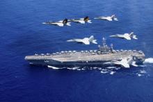 A combined formation of aircraft from Carrier Air Wing (CVW) 5 and Carrier Air Wing (CVW) 9 pass in formation above the Nimitz-class aircraft carrier USS John C. Stennis (CVN 74) in the Philippine Sea on June 18, 2016. Courtesy Steve Smith/U.S. Navy/Handout via REUTERS