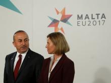 Turkey's Foreign Minister Mevlut Cavusoglu (L) talks with High Representative of the European Union for Foreign Affairs, Federica Mogherini, before a meeting with European Union Foreign Ministers in Valletta, Malta, April 28, 2017. PHOTO BY REUTERS/Darrin Zammit Lupi