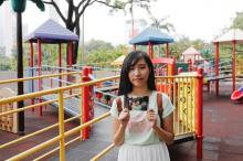 Chau Ho-oi, who was born six months before the Hong Kong's handover to Chinese rule in 1997, poses with her childhood photo which taken at the same spot in 1999, at Kowloon Park in Hong Kong, China, June 3, 2017. PHOTO BY REUTERS/Tyrone Siu