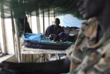A child sick with malaria and from malnutrition lies on a bed in a hospital in Bor March 15, 2014. PHOTO BY REUTERS/Andreea Campeanu