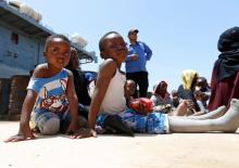 Migrants sit at a naval base after being rescued by Libyan coast guards in Tripoli, Libya, June 29, 2018. PHOTO BY REUTERS/Ismail Zitouny