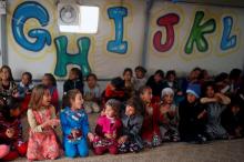 Displaced Iraqi children play inside a tent as they wait for the arrival of United Nations Secretary General Antonio Guterres during his visit at Hasansham camp, in Khazer, Iraq, March 31, 2017. PHOTO BY REUTERS/Suhaib Salem