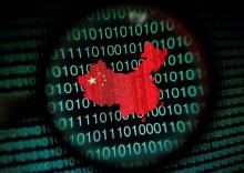 A map of China is seen through a magnifying glass on a computer screen showing binary digits in this January 2, 2014 photo illustration. PHOTO BY REUTERS/Edgar Su/Illustration