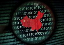 A map of China is seen through a magnifying glass on a computer screen showing binary digits in Singapore, in this January 2, 2014 file illustration photo. PHOTO BY REUTERS/Edgar Su