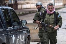 Christian fighters of Sutoro (The Syriac Security Office) carry their weapons as they man a checkpoint in the town of Tel Tamr, February 25, 2015. PHOTO BY REUTERS/Rodi Said