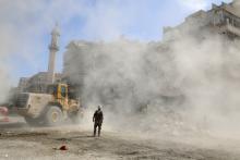 A Civil Defence member stands as a front loader removes debris after an air strike Sunday in the rebel-held besieged al-Qaterji neighbourhood of Aleppo, Syria. PHOTO BY REUTERS/Abdalrhman Ismail