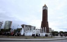 People sit in front of the clock tower at the end of Avenue Habib Bourguiba in Tunis, Tunisia, February 13, 2016. PHOTO BY REUTERS/Zoubeir Souissi