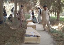 Relatives mourn next to the coffins of policemen who were killed after a Taliban attack on a military outpost in Baghlan province, Afghanistan, August 15, 2018. PHOTO BY REUTERS/Stringer