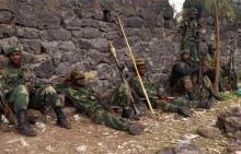 Congolese government soldiers take a break after patrolling in Kanyarucinya village in the outskirts of Goma