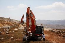 Heavy machinery work on a field as they begin construction work of Amichai, a new settlement which will house some 300 Jewish settlers evicted in February from the illegal West Bank settlement of Amona, in the West Bank, June 20, 2017. PHOTO BY REUTERS/Ronen Zvulun
