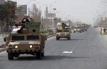 A convoy of Iraqi defense forces arrives near the town of Baiji, September 7, 2015. PHOTO BY REUTERS/Stringer