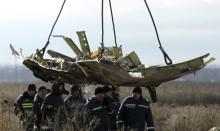 A crane transports a piece of the Malaysia Airlines flight MH17 wreckage at the site of the plane crash near the village of Hrabove (Grabovo) in Donetsk region, eastern Ukraine, November 20, 2014. PHOTO BY REUTERS/Antonio Bronic