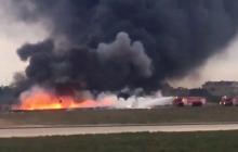 Still image taken from video shows fire trucks aiming their hoses at the burning wreckage of a small plane which crashed at the edge of the runway at the airport in Valletta, Malta, October 24, 2016. PHOTO BY REUTERS