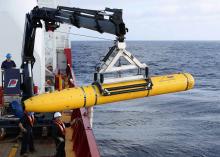 Crew aboard the Australian Defence Vessel Ocean Shield move the U.S. Navy's Bluefin-21 autonomous underwater vehicle into position for deployment in the southern Indian Ocean to look for the missing Malaysia Airlines flight MH370