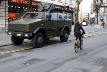 A cyclist rides past a military armoured vehicle in central Brussels, December 31, 2015. PHOTO BY REUTERS/Francois Lenoir